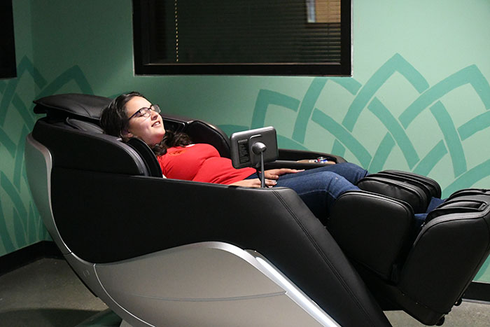 young woman relaxing in a massage chair