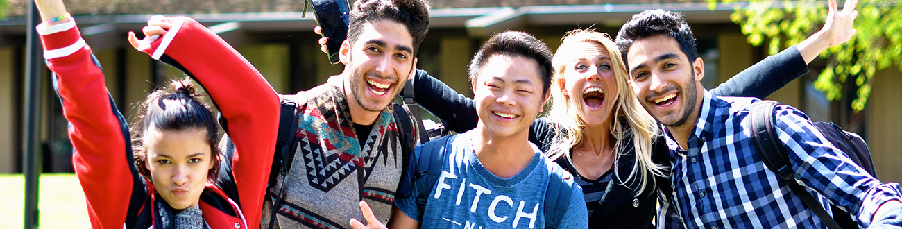 Group of five smiling students