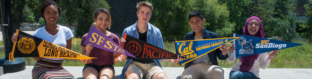 Students holding university pendants