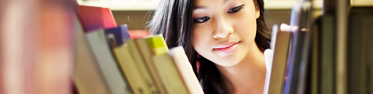 Female student looking at books
