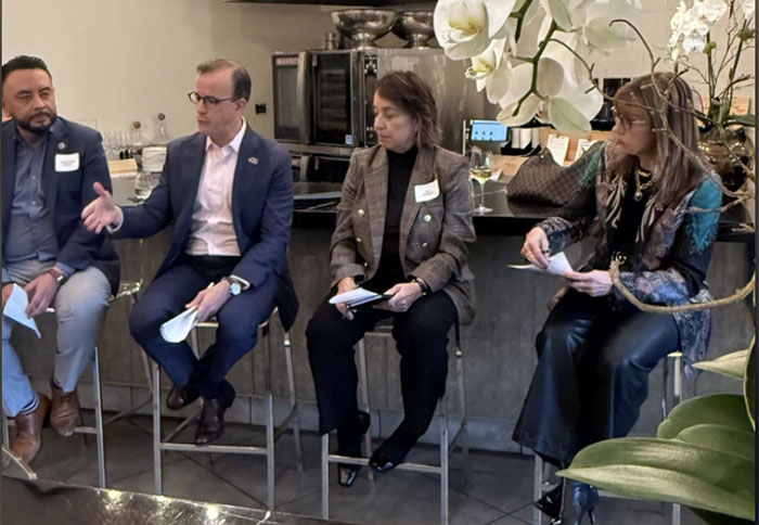 Group of four people sitting on stools