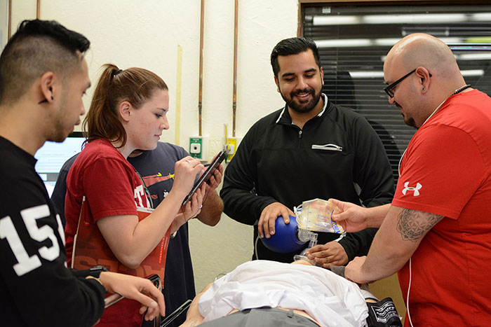 a group of student working on a simulated patient